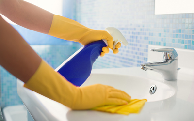 Person Cleaning the Bathroom Sink